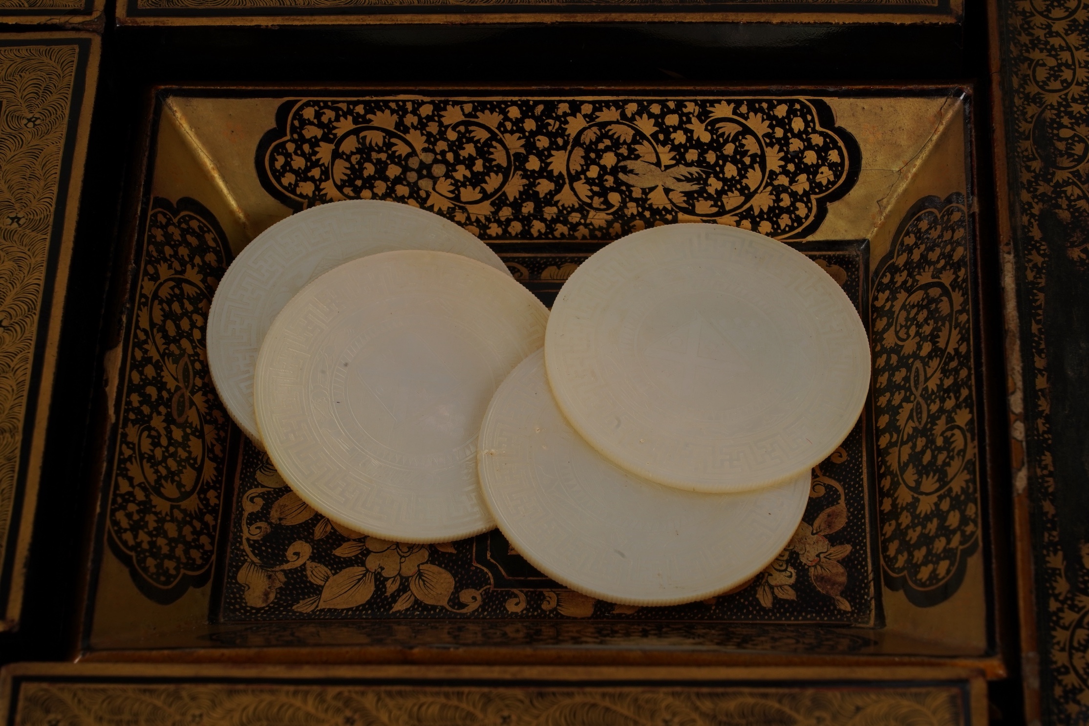 Two Chinese gilt decorated black lacquer games boxes, containing numerous mother-of-pearl counters, 19th century